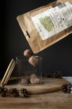 Hokuō® Elk & Cranberry freeze-dried pet treats with Estonian wild elk meat and cranberries on wooden board with pinecones