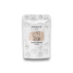 Hokuō® Lamb Bone Broth pet supplement pouch with lamb illustration and paw prints pattern