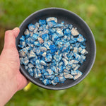 Bowl of freeze-dried chicken pieces mixed with blue spirulina pet treats for dogs and cats