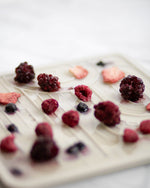 Freeze-dried berries mix of blackberries, blueberries, raspberries, and strawberries on white surface